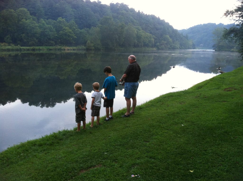 Elderly Man and Three Children Fishing