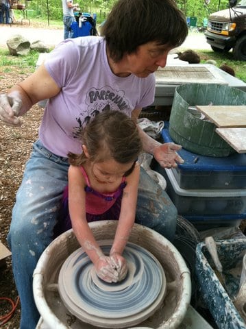 Elderly Woman and Child Making Clay Pottery